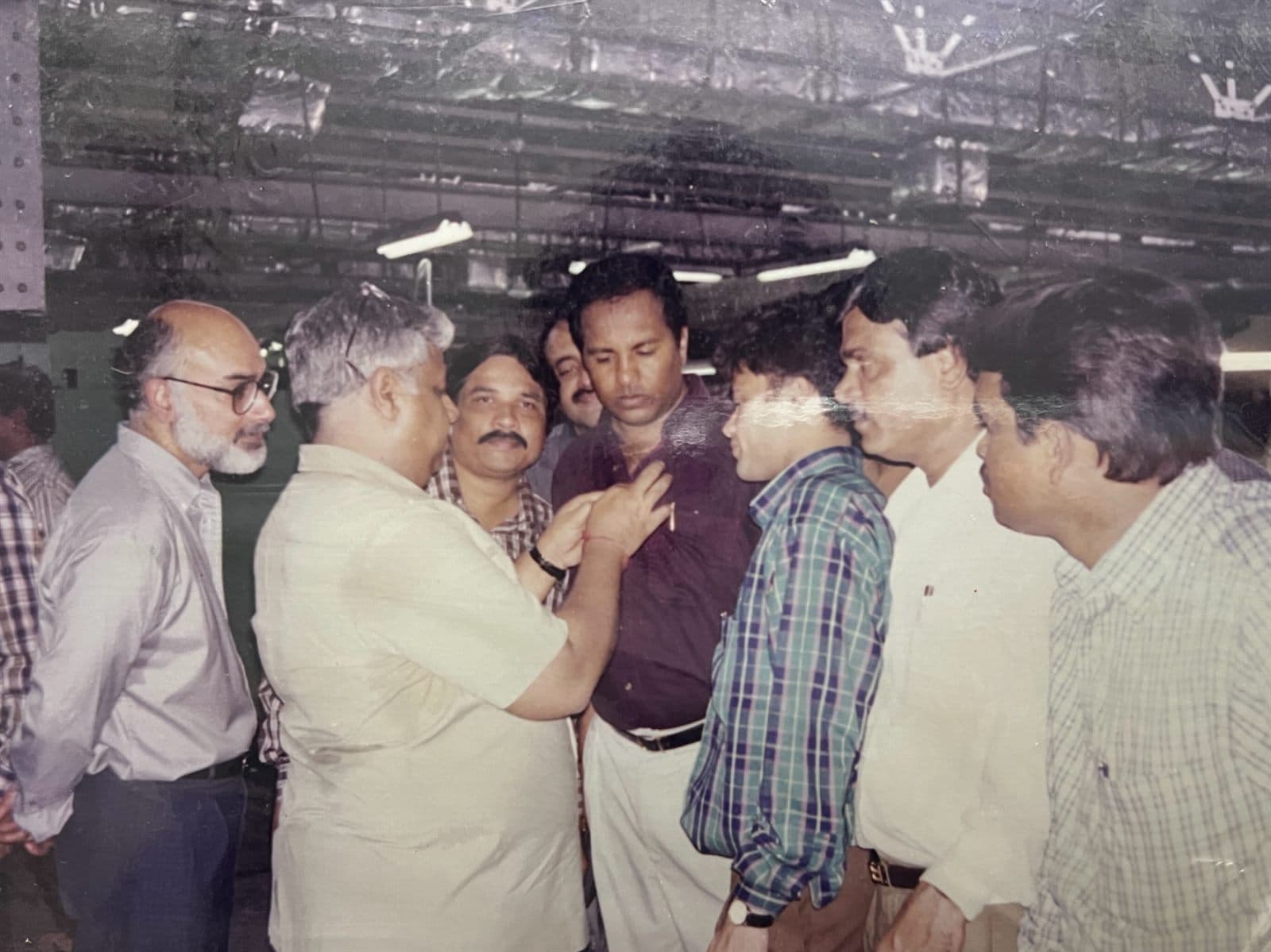 CEO Akbar Khan on Technical Tour at Digjam Mill (2000s) - CEO Mr. Akbar Khan inspecting woolen manufacturing looms, weave density, and yarn quality control directly on the factory floor at Digjam Mill. | MF.Khan Heritage Archives Visakhapatnam