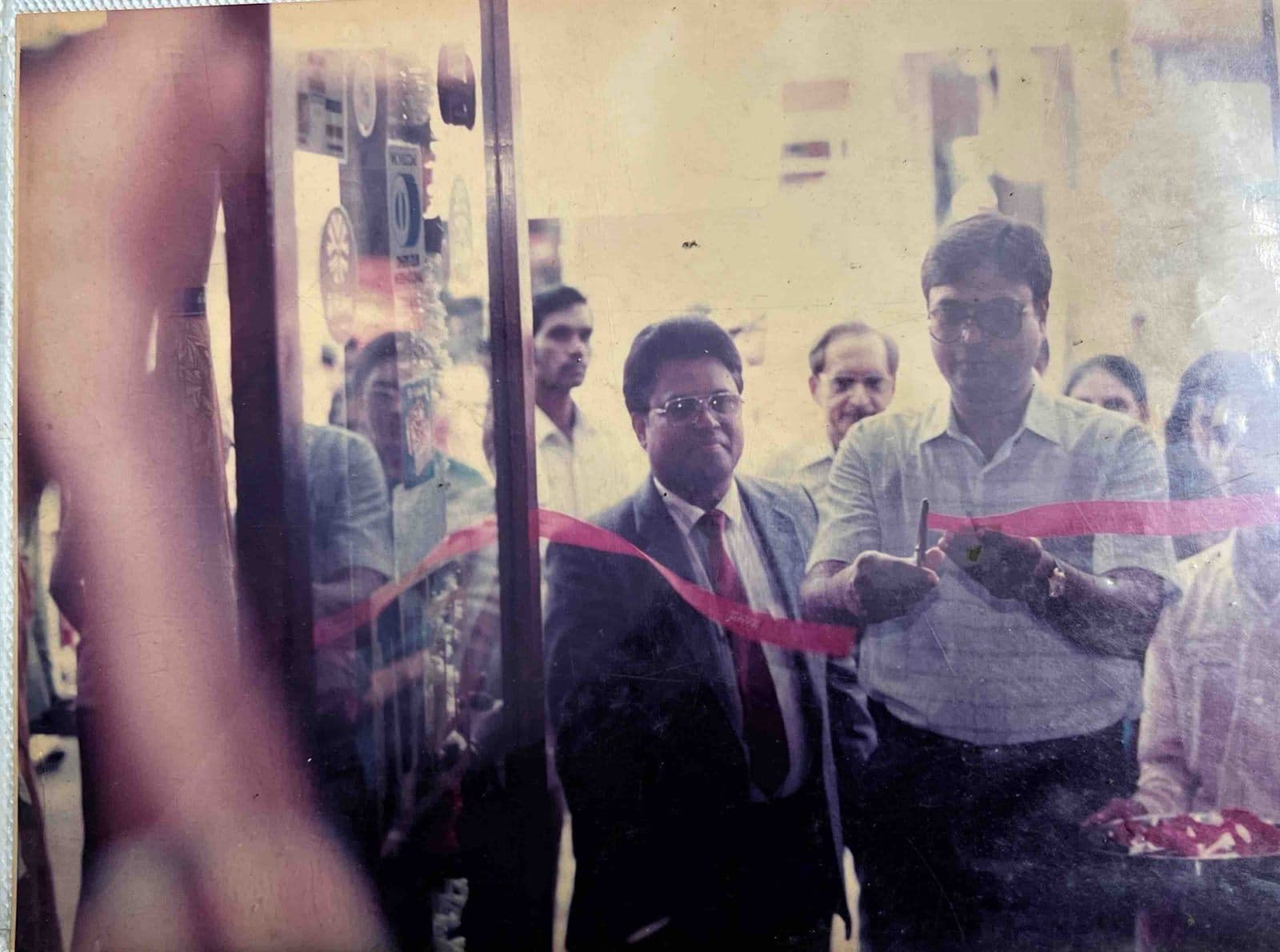 Ceremonial Ribbon-Cutting & Showroom Inauguration (1980s - 1990s) - Dignitary performing the ceremonial ribbon-cutting to inaugurate the expanded air-conditioned showroom alongside Chairman Ahmed Ali Khan. | MF.Khan Heritage Archives Visakhapatnam
