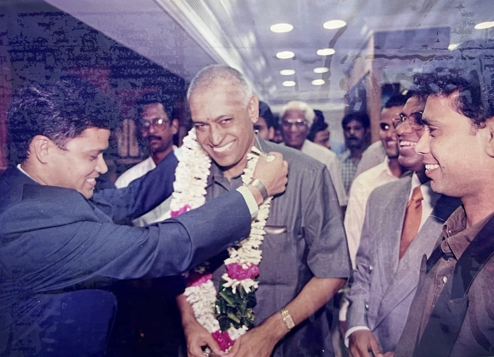Felicitation of Dr. K. Parvathi Kumar Garu at Store Opening (1990s) - Revered spiritual leader, philosopher, and international author Dr. K. Parvathi Kumar Garu being warmly felicitated with floral garlands during a grand new store opening in Visakhapatnam. | MF.Khan Heritage Archives Visakhapatnam