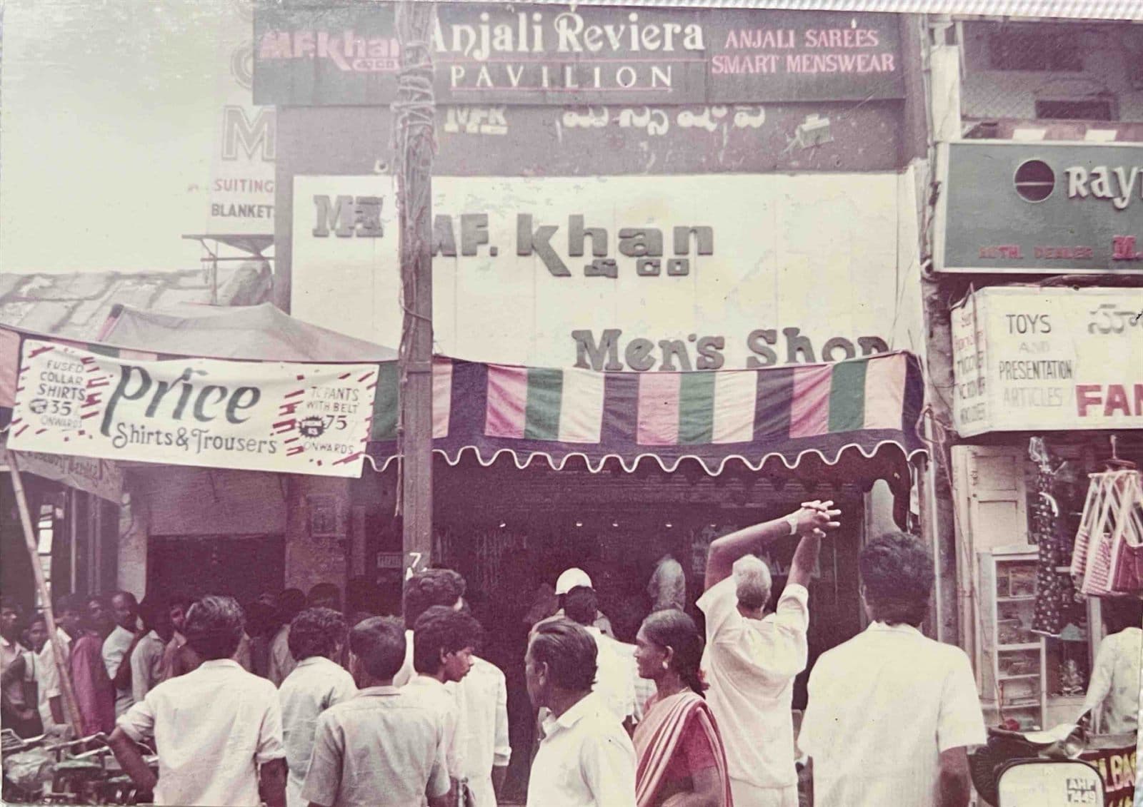 Peak Wedding & Festive Season Rush (1980s - 1990s) - A bustling street scene outside the iconic "MF.Khan Men’s Shop" and Anjali Pavilion storefront during the peak festive shopping and wedding season in Visakhapatnam. | MF.Khan Heritage Archives Visakhapatnam