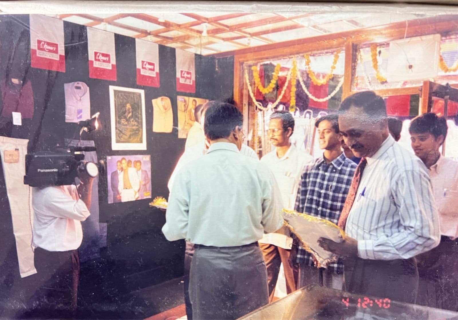 Grand New Store Opening Ceremony (1990s) - Festive inaugural gathering with patrons, camera press, and traditional floral decor during the grand opening of a new MF.Khan establishment in Visakhapatnam. | MF.Khan Heritage Archives Visakhapatnam