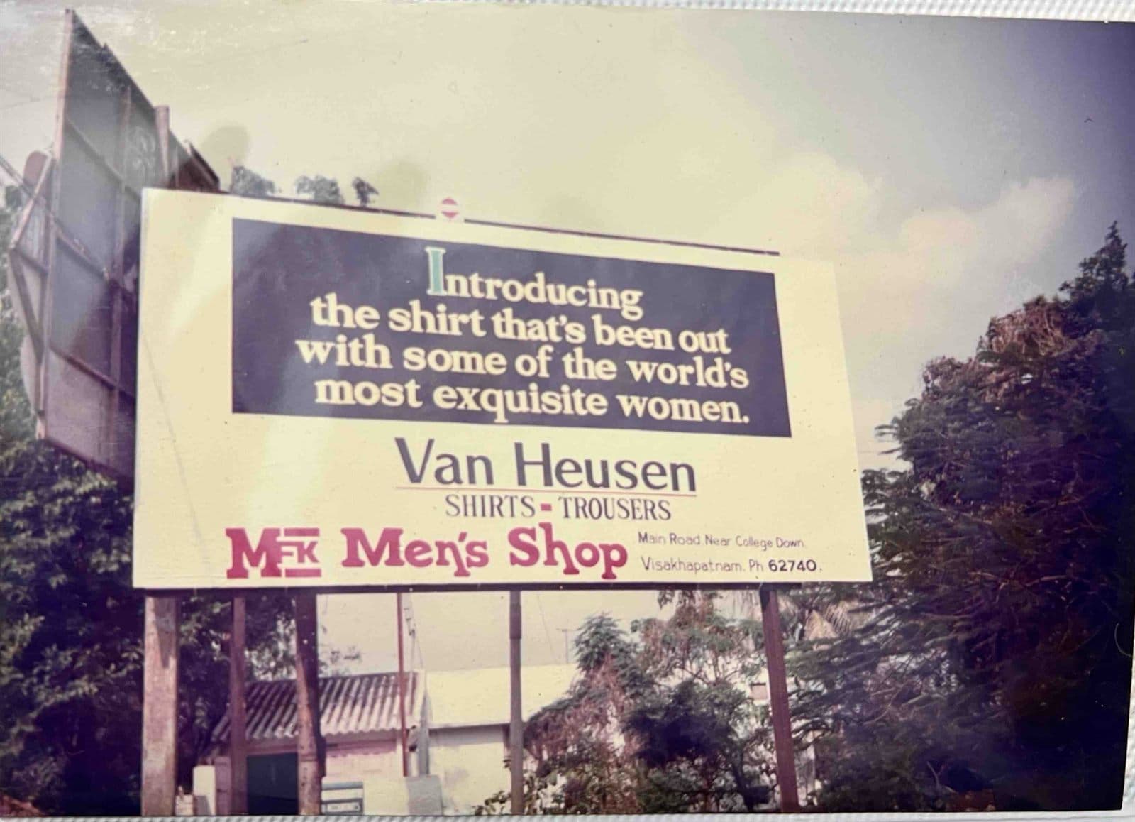 Landmark City Billboard for MF.Khan Menswear (1980s) - Archival photograph of a prominent outdoor billboard advertisement in Visakhapatnam announcing premium suiting and shirt collections by MF.Khan. | MF.Khan Heritage Archives Visakhapatnam